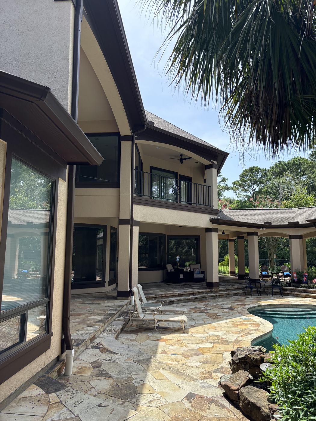 Exterior paint finished — gable and patio cover by pool