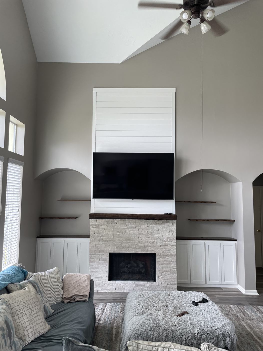 Shiplap accent wall with matching built-in cabinets and floating shelves